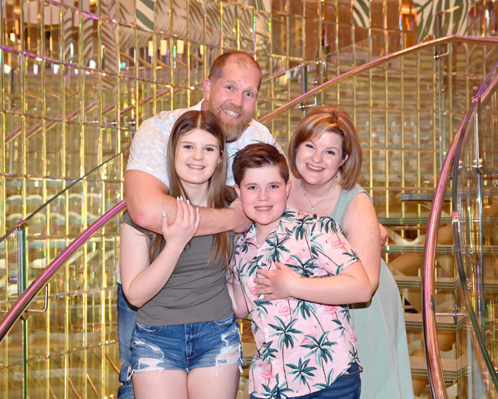 Photo of Kendra of Portraits by Kendra and her family taken on staircase on board a Carnival cruise vacation