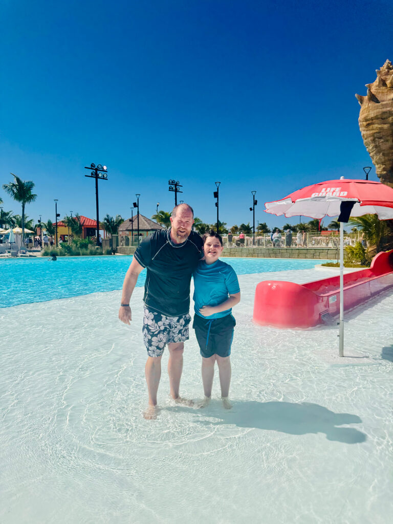 Photo of ∂ad and son having fun in the water during an excursion with Carnival