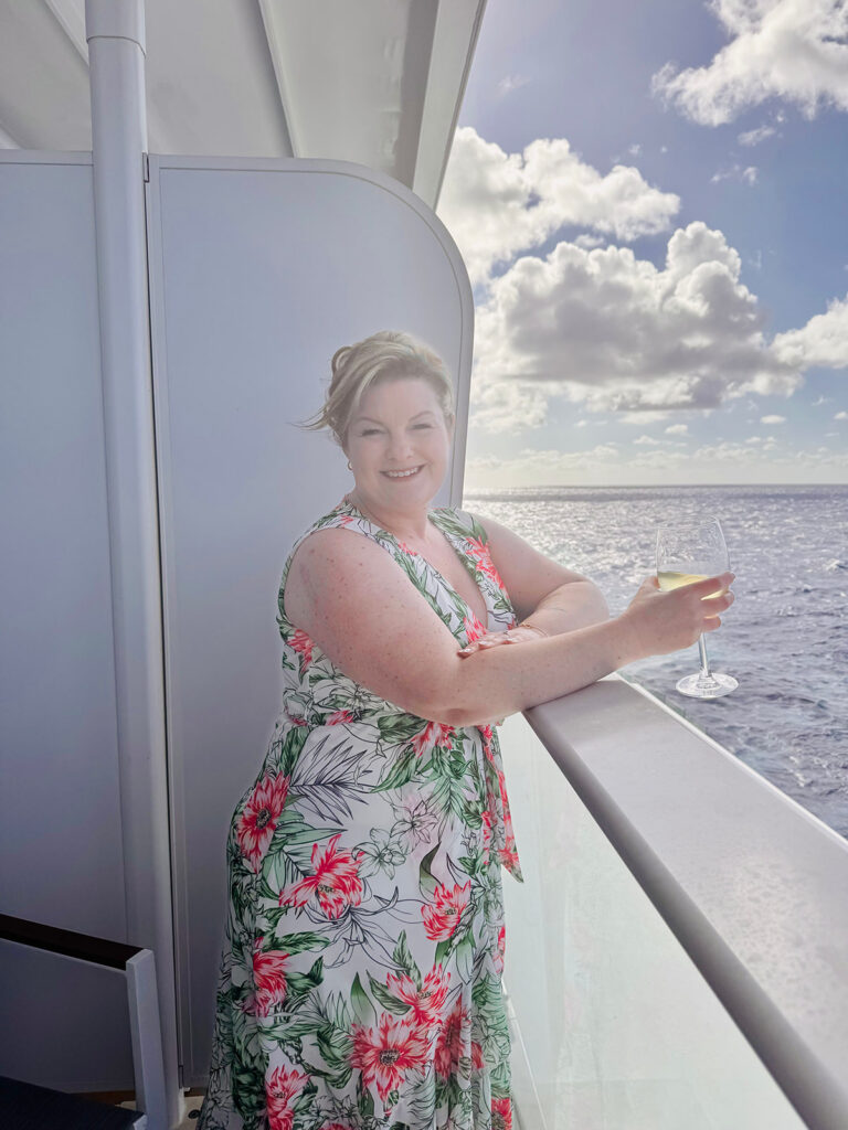 Kendra of Portraits by Kenddra enjoying an evening glass of wine during a Carnival Cruise vacation