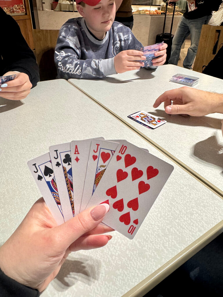 Family playing cards at Toronto airport during travel delay