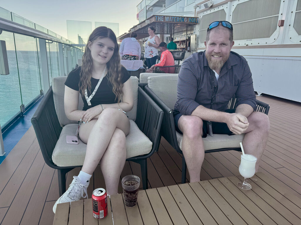 Photo of ∂ad and daughter relaxing on board a carnival cruise ship