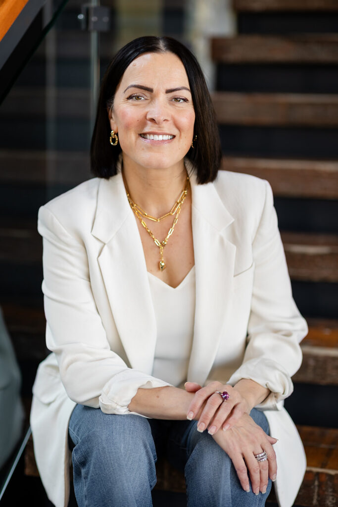 Modern LinkedIn Headshot of woman sitting on stairs photographed in Kitchener-Waterloo  by Portraits by Kendra