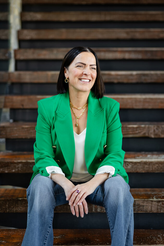 Modern LinkedIn Headshot of woman sitting on stairs photographed in Kitchener-Waterloo  by Portraits by Kendra