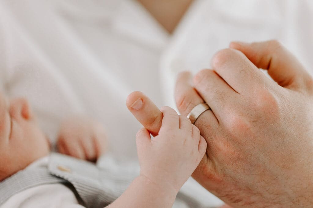 Newborn detail photo, baby hand holding parent's finger, lifestyle photography Kitchener-Waterloo."