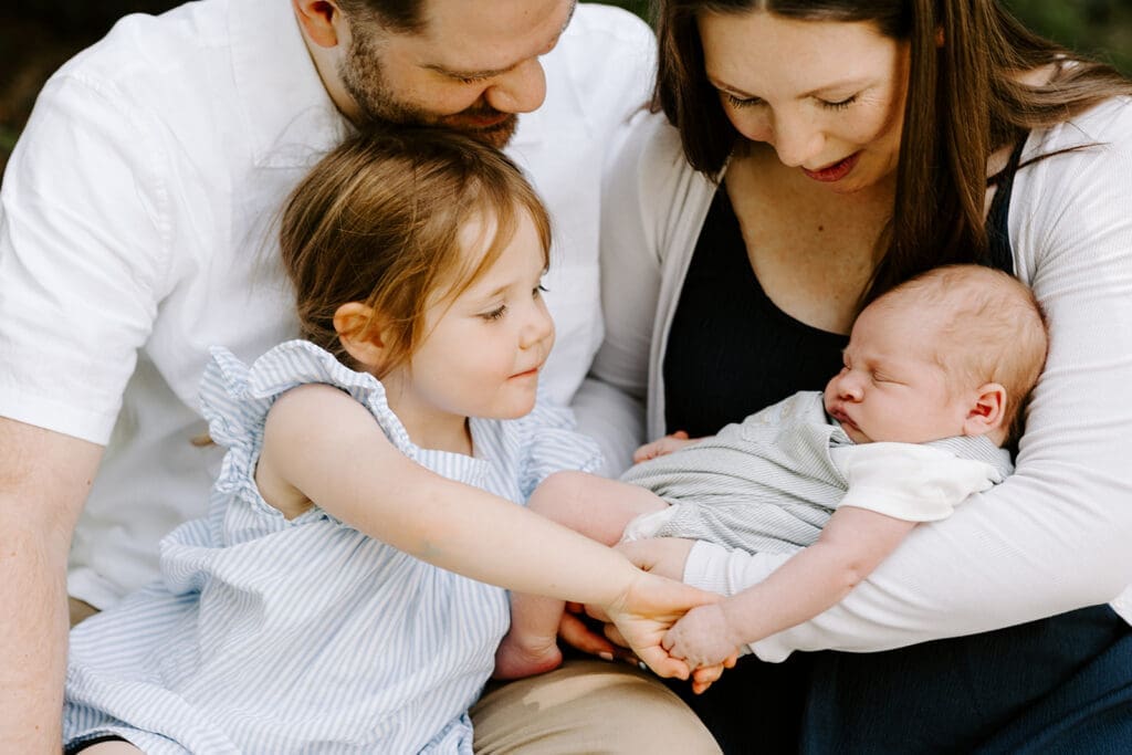 Lifestyle family newborn session at home in Kitchener-Waterloo, mom, dad and sibling with newborn baby.
