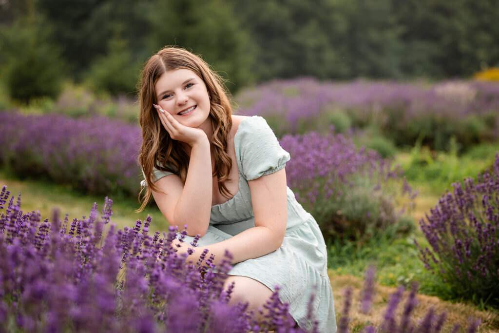 Birthday portrait of teen girl crouching lavender field in Ayr. 