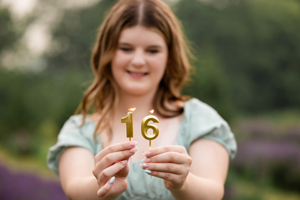 Close-up photo of teen girl on her sixteenth birthday, standing in a lavender field.