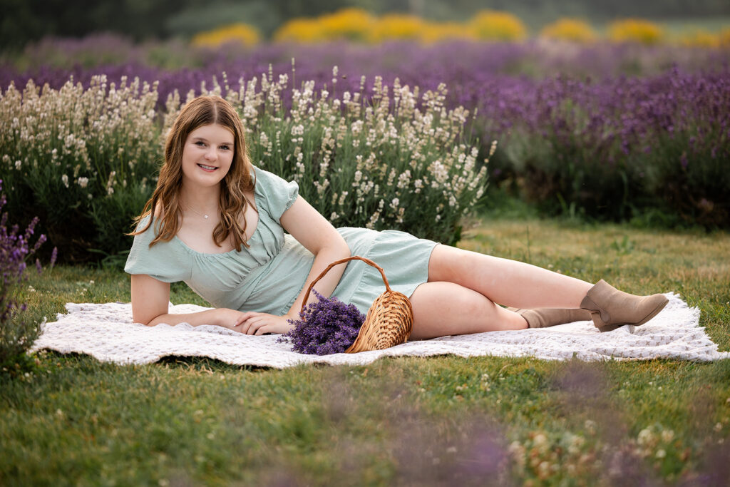 Birthday portrait session of a teen girl laying on a blanket in a lavender farm in Ayr, Ontario, golden hour natural light photography.