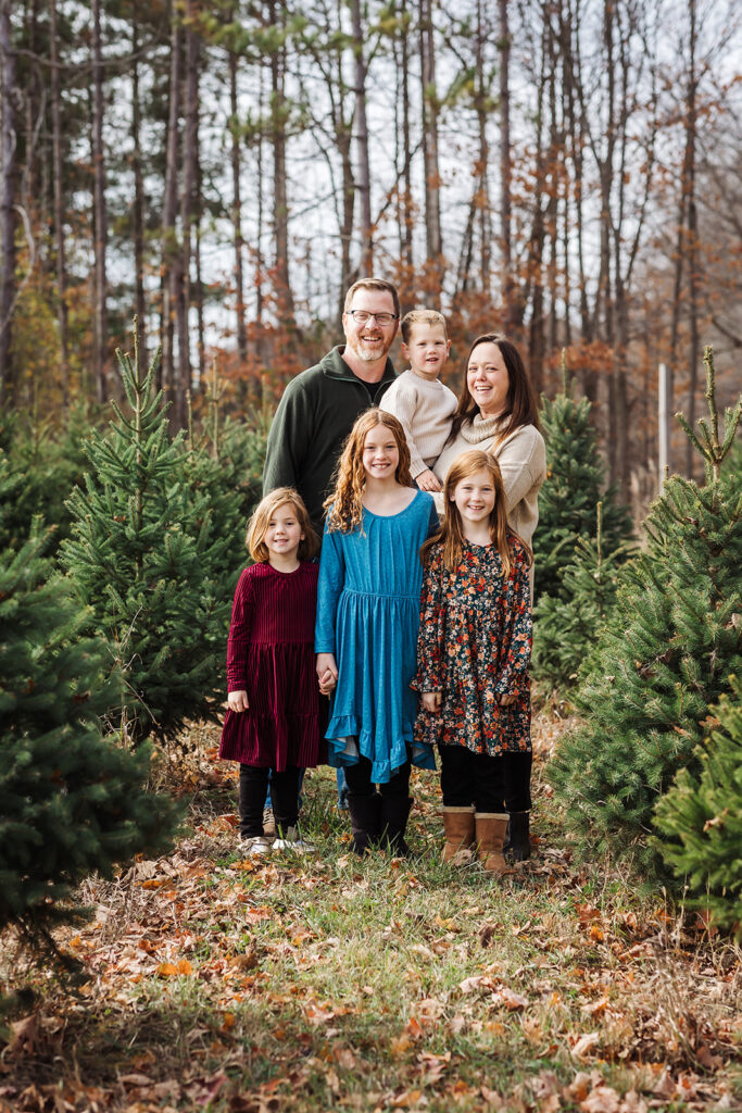 Family of six posing together outdoors during a fall family photography session in Kitchener-Waterloo.